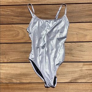Woman’s silver one peice swim suit